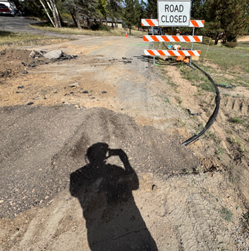 Photo of road closed and road condition next to road closed sign.